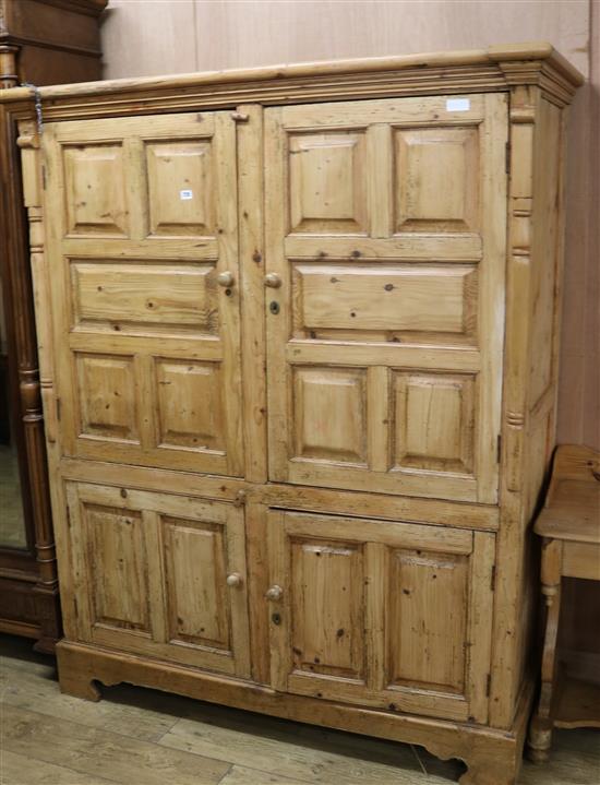 A Continental pine cupboard, enclosed by four fielded panelled doors W.152cm